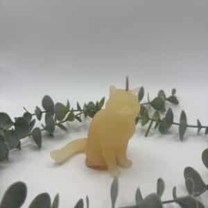 Een oranje kaars in de vorm van een kat.