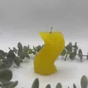 Een gele kaars in de vorm van een golf.